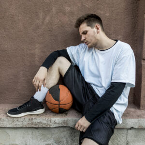 front view man relaxing with basketball