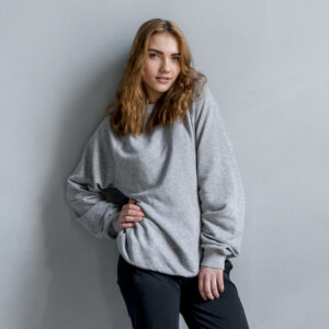 portrait beautiful young woman standing against grey wall